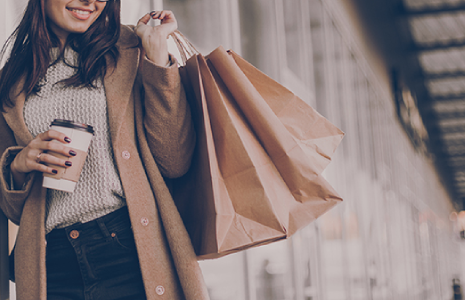 Directory CTA woman holding kraft paper shopping bags